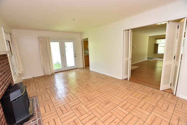 1200 S Longwood Dr, Bloomington, IN 47401 - unfurnished living room with a wood stove and baseboards