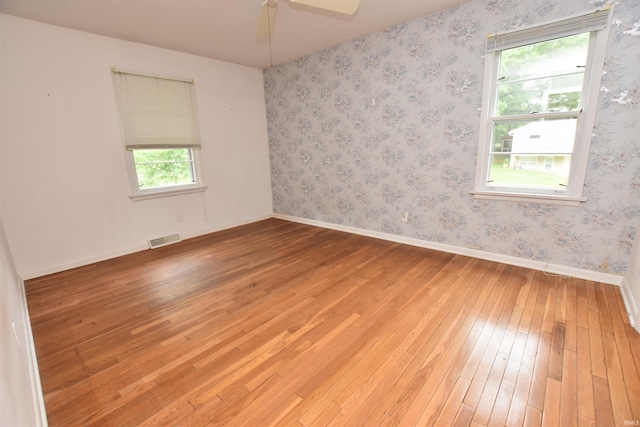 1200 S Longwood Dr, Bloomington, IN 47401 - spare room with light wood-style flooring, a ceiling fan, and baseboards