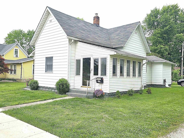 220 W Main St, Greentown, IN 46936 - view of front of property with a chimney, a front lawn, and roof with shingles