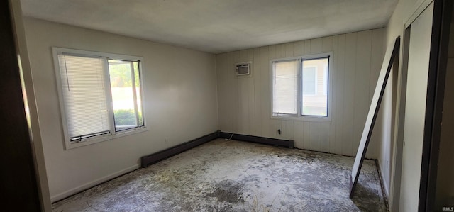 5002 Canterbury Dr, Fort Wayne, IN 46835 - empty room with plenty of natural light, a wall mounted air conditioner, baseboards, wood walls, and a baseboard heating unit