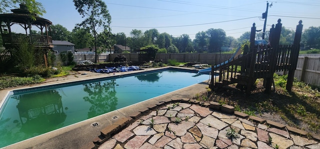 5002 Canterbury Dr, Fort Wayne, IN 46835 - view of swimming pool with a fenced backyard, stairs, a diving board, and a patio