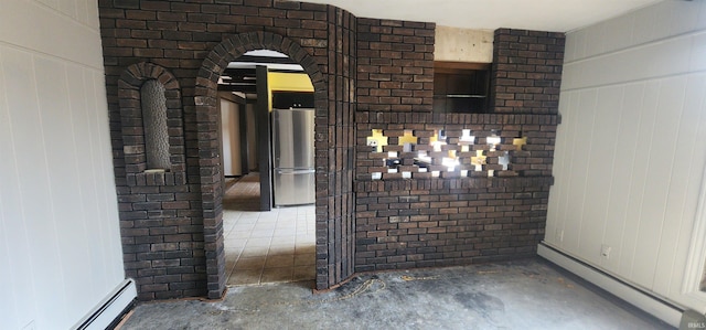 5002 Canterbury Dr, Fort Wayne, IN 46835 - detailed view of baseboard heating, unfinished concrete floors, freestanding refrigerator, and arched walkways