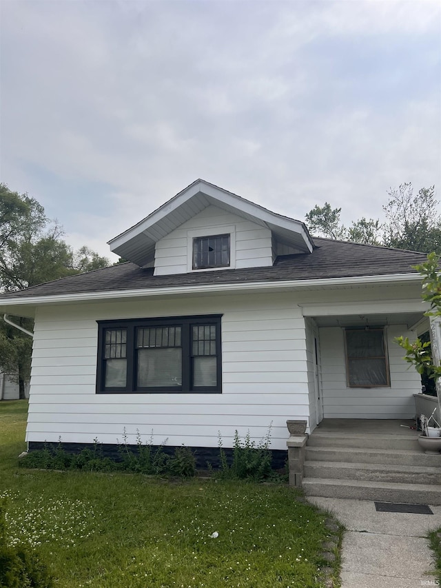 2319 S Main St, Elkhart, IN 46517 - view of front facade with a front yard, covered porch, and roof with shingles