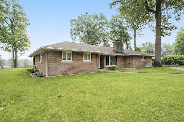 55916 Jayne Dr, Elkhart, IN 46514 - ranch-style house featuring brick siding, a front lawn, a chimney, and roof with shingles