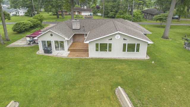 55916 Jayne Dr, Elkhart, IN 46514 - view of front facade featuring a patio area, a front lawn, roof with shingles, and a chimney