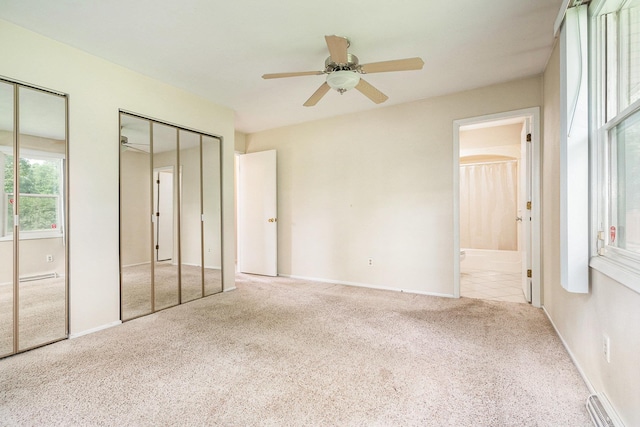 18363 Sheffield Ln, Bristol, IN 46507 - unfurnished bedroom with two closets, carpet flooring, ensuite bath, baseboards, and a ceiling fan