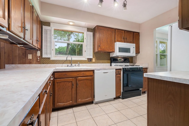 18363 Sheffield Ln, Bristol, IN 46507 - kitchen with white appliances, a sink, decorative backsplash, light countertops, and healthy amount of natural light