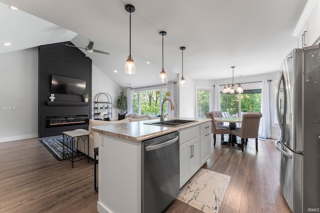 16995 Hatstick Ct, Fort Wayne, IN 46845 - kitchen featuring appliances with stainless steel finishes, a sink, white cabinetry, wood finished floors, and a kitchen island with sink