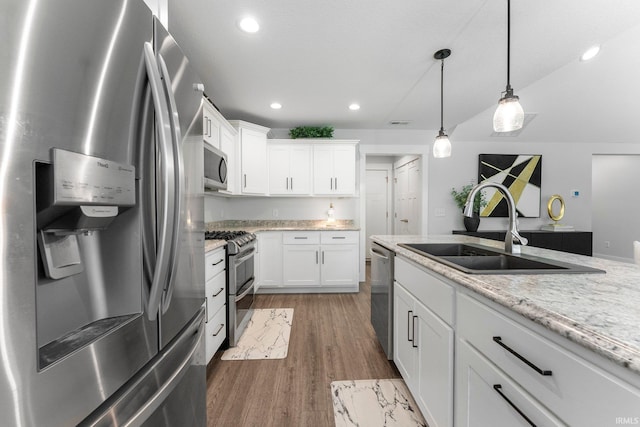 16995 Hatstick Ct, Fort Wayne, IN 46845 - kitchen with appliances with stainless steel finishes, a sink, wood finished floors, white cabinets, and recessed lighting