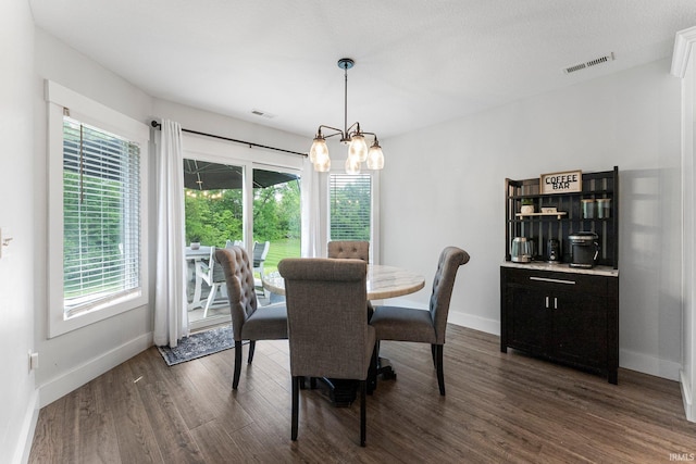 16995 Hatstick Ct, Fort Wayne, IN 46845 - dining room with baseboards, a chandelier, and dark wood-type flooring