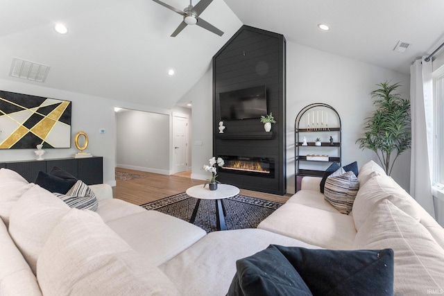 16995 Hatstick Ct, Fort Wayne, IN 46845 - living room featuring vaulted ceiling, ceiling fan, wood finished floors, a fireplace, and recessed lighting