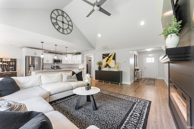16995 Hatstick Ct, Fort Wayne, IN 46845 - living room with a ceiling fan, light wood-style floors, high vaulted ceiling, recessed lighting, and baseboards