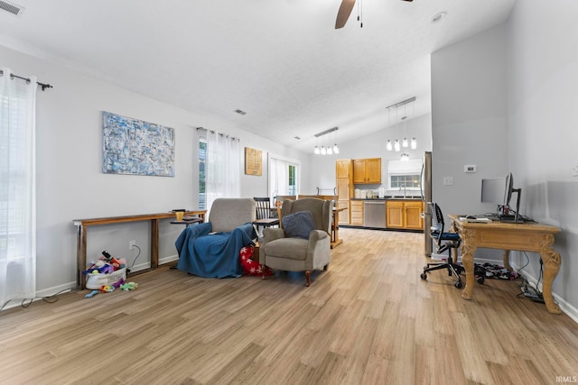 5405 N Andrea Dr, Bloomington, IN 47404 - living room with light wood-style floors, ceiling fan, vaulted ceiling, a desk, and baseboards