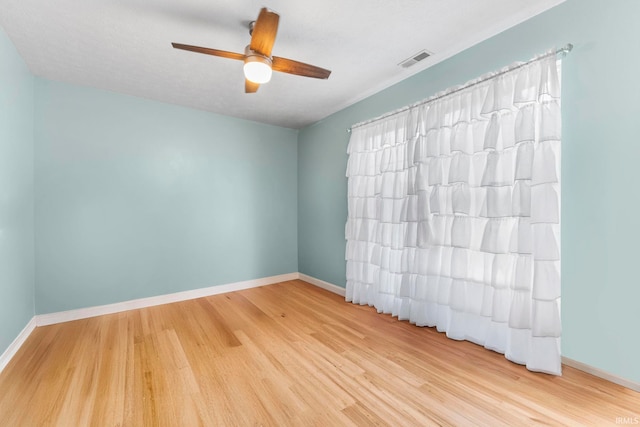 5405 N Andrea Dr, Bloomington, IN 47404 - unfurnished room with wood finished floors, ceiling fan, and baseboards