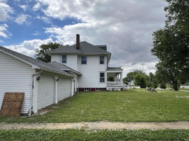 102 W Hackett St, Carlisle, IN 47838 - rear view of house with a chimney, an attached garage, a yard, a shingled roof, and a porch