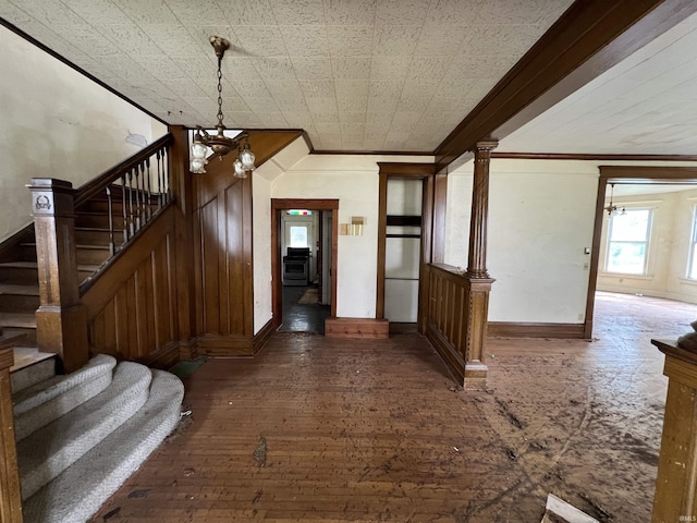 102 W Hackett St, Carlisle, IN 47838 - entryway with ornamental molding, stairway, baseboards, a chandelier, and wood-type flooring