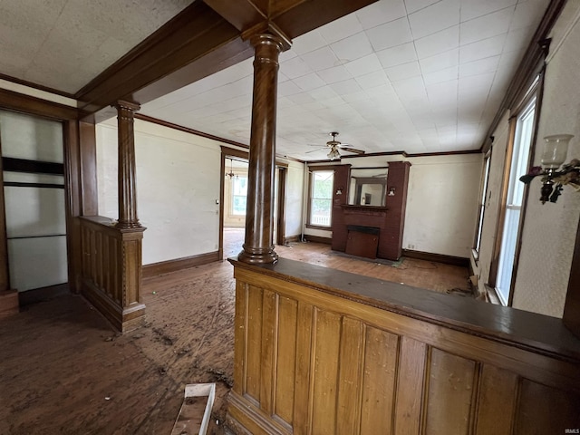 102 W Hackett St, Carlisle, IN 47838 - unfurnished living room with crown molding, a brick fireplace, decorative columns, ceiling fan, and baseboards