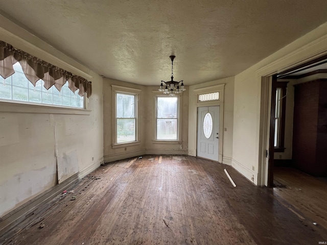 102 W Hackett St, Carlisle, IN 47838 - unfurnished dining area with a chandelier, hardwood / wood-style flooring, plenty of natural light, and a textured ceiling