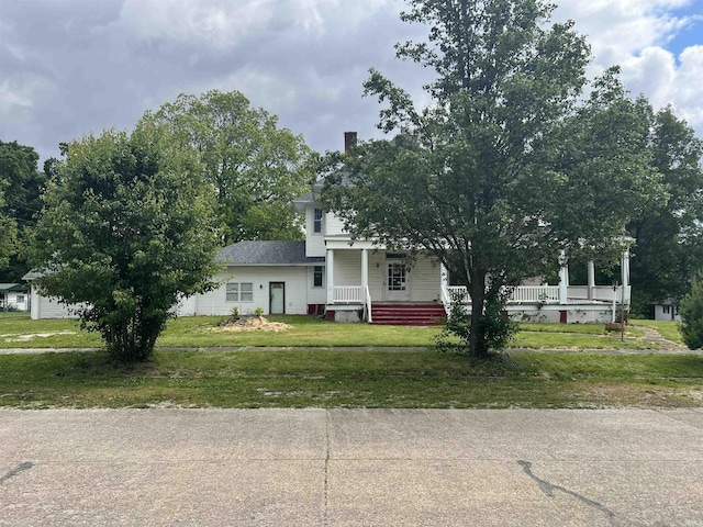 102 W Hackett St, Carlisle, IN 47838 - view of front of house featuring a porch and a front yard