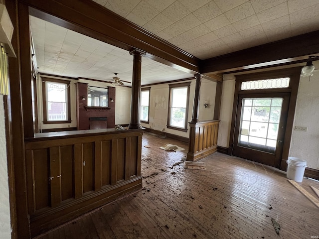 102 W Hackett St, Carlisle, IN 47838 - foyer entrance featuring ornate columns, hardwood / wood-style floors, a ceiling fan, baseboards, and crown molding