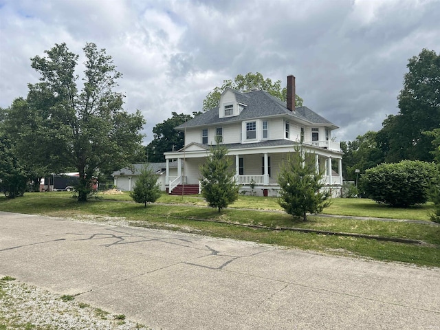 102 W Hackett St, Carlisle, IN 47838 - view of front of property featuring a porch, a chimney, a front lawn, and a shingled roof