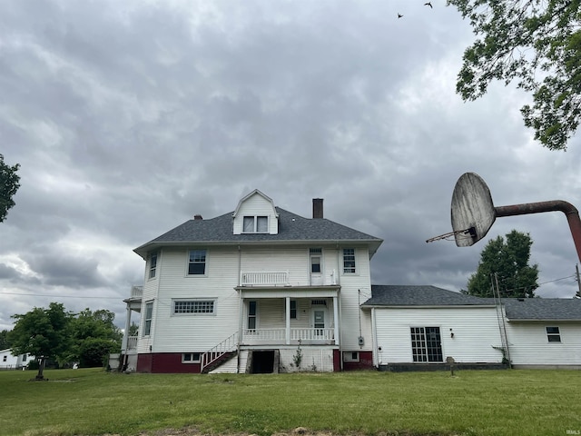 102 W Hackett St, Carlisle, IN 47838 - back of property with a chimney, a lawn, covered porch, and roof with shingles