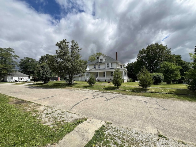 102 W Hackett St, Carlisle, IN 47838 - victorian house with a chimney, a porch, and a front yard