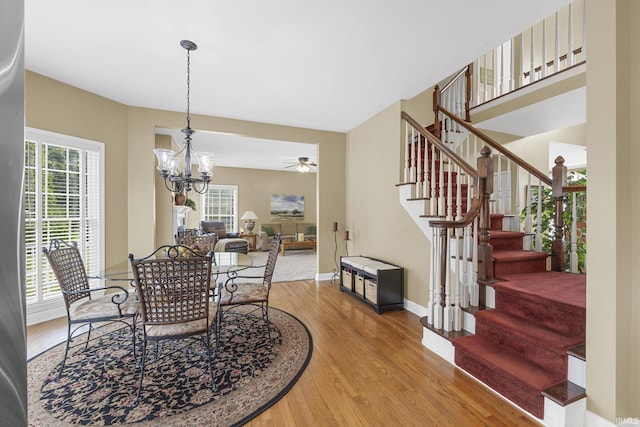 3 Brownstone Ct, Jasper, IN 47546 - dining area featuring wood finished floors, stairway, a chandelier, baseboards, and a ceiling fan