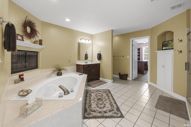 3 Brownstone Ct, Jasper, IN 47546 - bathroom featuring vanity, a tub with jets, tile patterned flooring, baseboards, and recessed lighting