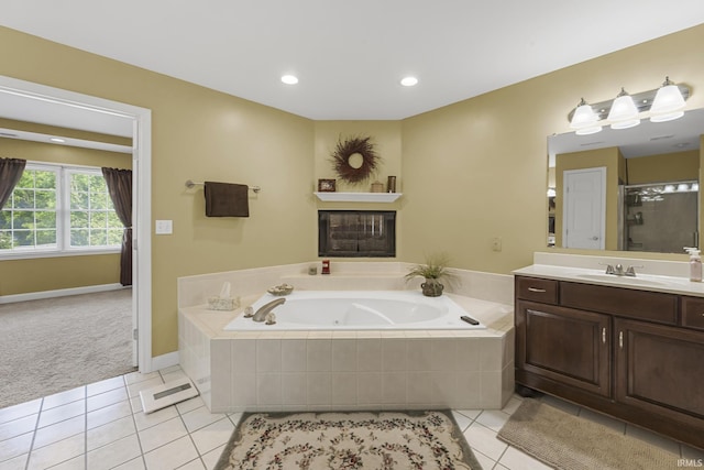 3 Brownstone Ct, Jasper, IN 47546 - full bathroom with vanity, tile patterned flooring, a jetted tub, a glass covered fireplace, and recessed lighting
