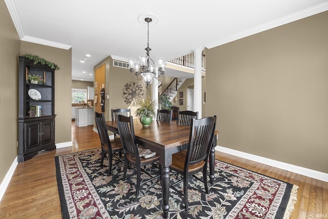 3 Brownstone Ct, Jasper, IN 47546 - dining space with a chandelier, baseboards, wood finished floors, ornamental molding, and recessed lighting