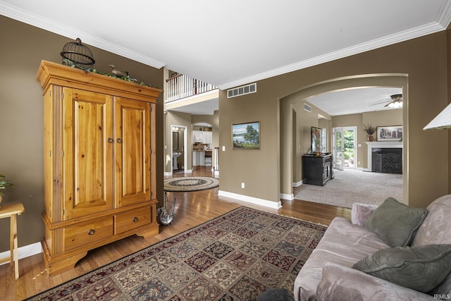 3 Brownstone Ct, Jasper, IN 47546 - living area featuring arched walkways, baseboards, a fireplace, wood finished floors, and ornamental molding