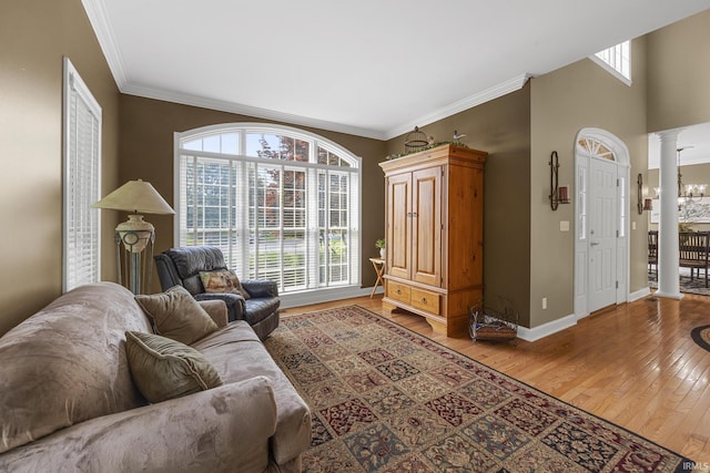 3 Brownstone Ct, Jasper, IN 47546 - living area with decorative columns, light wood-style flooring, crown molding, and baseboards