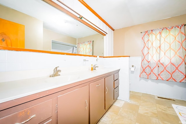 6613 E Hickory Ln, Muncie, IN 47303 - full bath featuring double vanity and a wainscoted wall