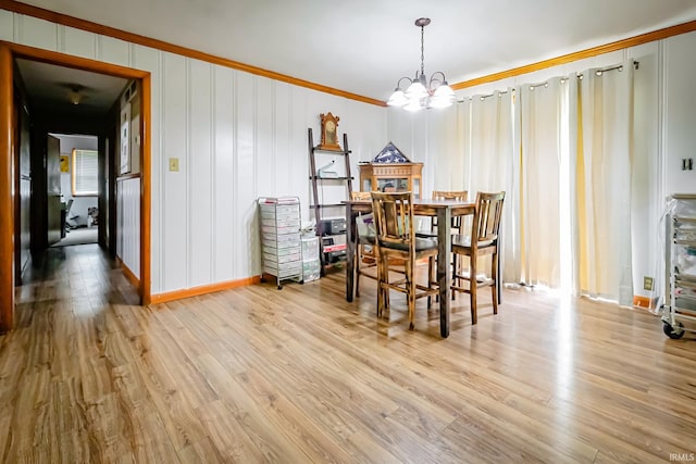 6613 E Hickory Ln, Muncie, IN 47303 - dining area featuring a chandelier, wood finished floors, crown molding, and baseboards