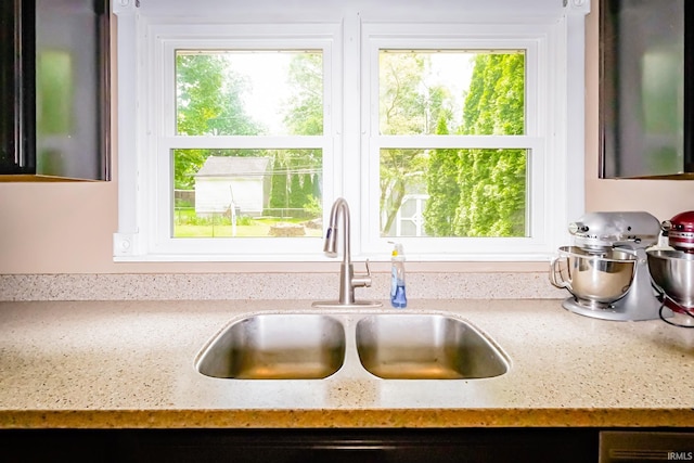 6613 E Hickory Ln, Muncie, IN 47303 - kitchen view of a sink, light stone counters, and dishwasher