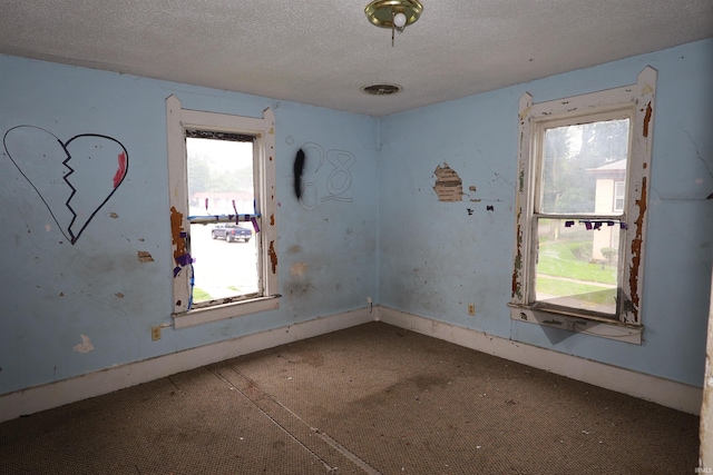 744 First St, Huntington, IN 46750 - carpeted empty room featuring a textured ceiling and baseboards