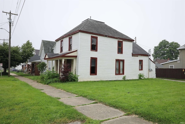 744 First St, Huntington, IN 46750 - view of home's exterior with a shingled roof and a lawn
