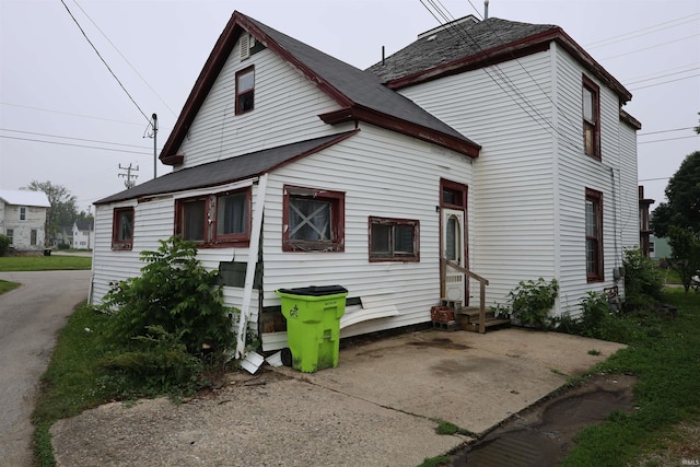 744 First St, Huntington, IN 46750 - rear view of property featuring entry steps and a shingled roof