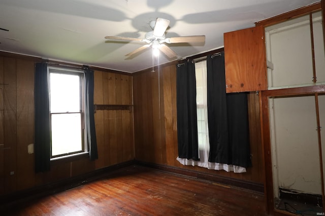 744 First St, Huntington, IN 46750 - empty room featuring hardwood / wood-style flooring, ceiling fan, and wood walls