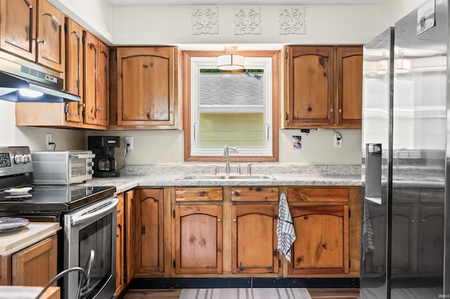 6521 Snug Harbour Ln, Unionville, IN 47468 - kitchen with appliances with stainless steel finishes, a sink, under cabinet range hood, and brown cabinetry