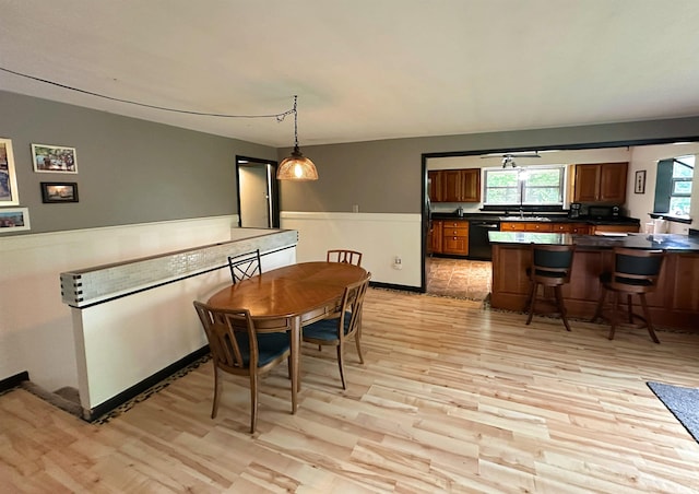 302 S Edgewood Dr, Ellettsville, IN 47429 - dining space with light wood-style flooring and a wainscoted wall