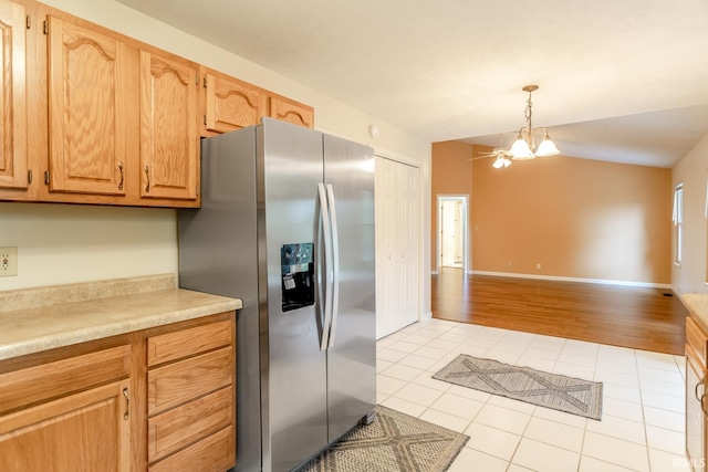 4331 Hadley Ct, West Lafayette, IN 47906 - kitchen featuring stainless steel fridge, light tile patterned floors, light countertops, open floor plan, and a chandelier