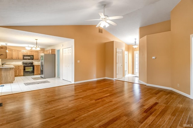 4331 Hadley Ct, West Lafayette, IN 47906 - unfurnished living room featuring light wood-style floors, lofted ceiling, ceiling fan, a chandelier, and a sink