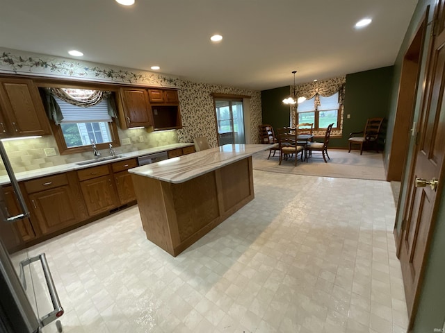404 Ridge Ct, Ossian, IN 46777 - kitchen featuring a sink, light countertops, a chandelier, a kitchen island, and dishwasher