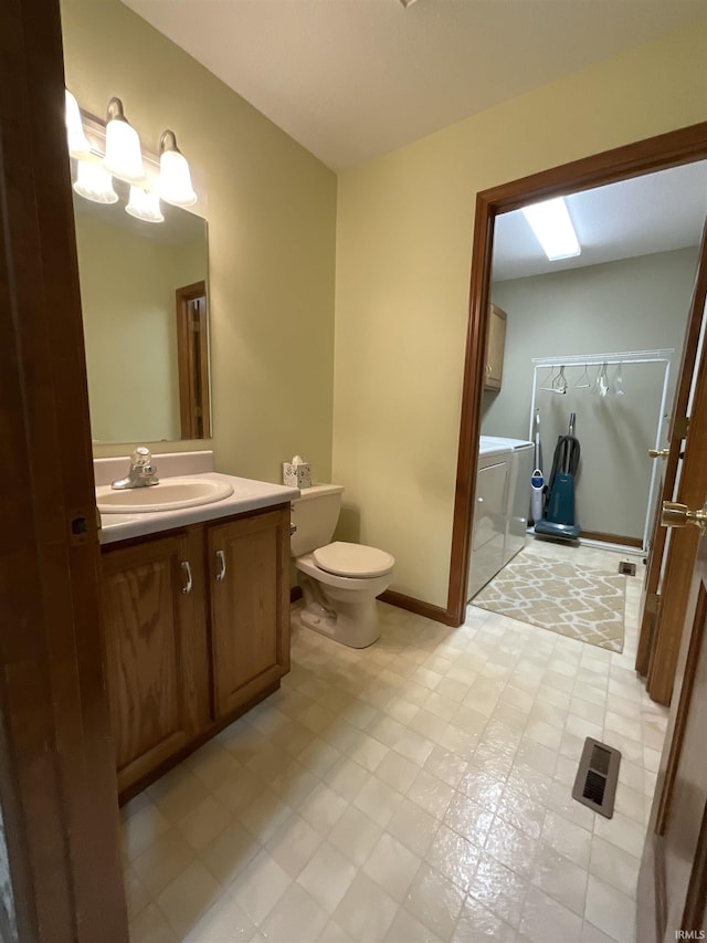 404 Ridge Ct, Ossian, IN 46777 - full bath with vanity, toilet, washing machine and clothes dryer, a walk in shower, and baseboards