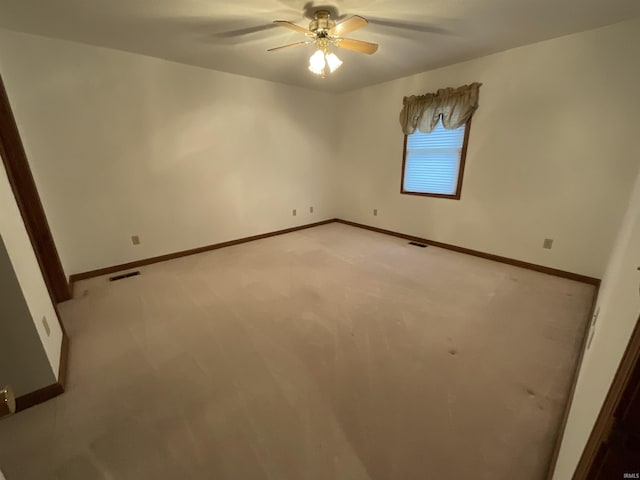 404 Ridge Ct, Ossian, IN 46777 - empty room with a ceiling fan, baseboards, and light colored carpet