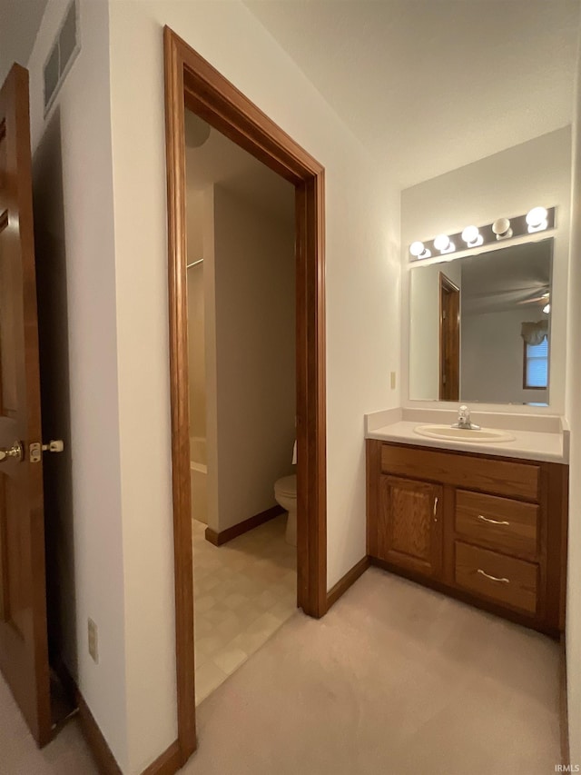 404 Ridge Ct, Ossian, IN 46777 - bathroom featuring toilet, vanity, and baseboards