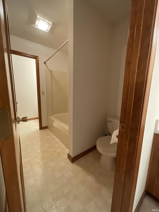 404 Ridge Ct, Ossian, IN 46777 - bathroom featuring toilet, shower / bathtub combination, and baseboards
