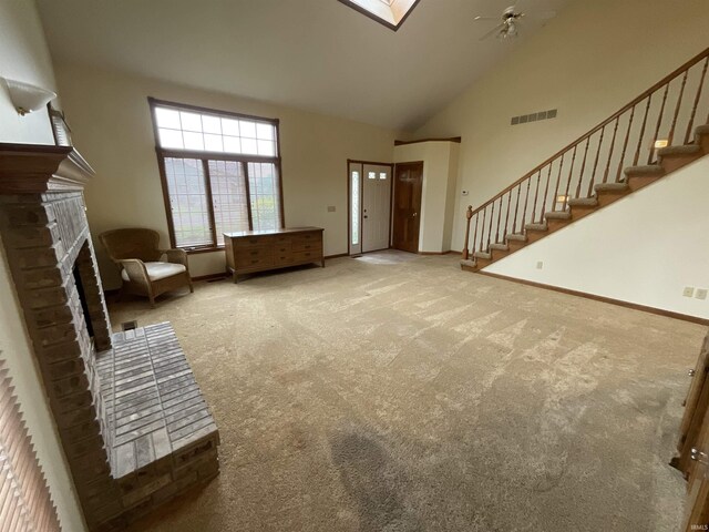 404 Ridge Ct, Ossian, IN 46777 - unfurnished living room with carpet flooring, high vaulted ceiling, stairs, a fireplace, and baseboards